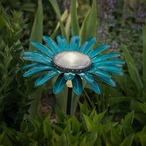 Teal Daisy Solar Light, lit in garden