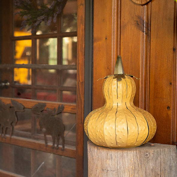 Yellow Gourd Luminary on porch next to window