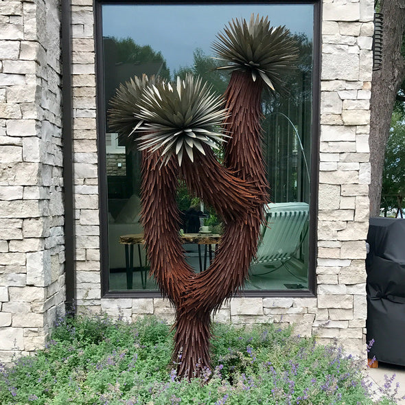 Three Arm metal Joshua Tree in front of home window