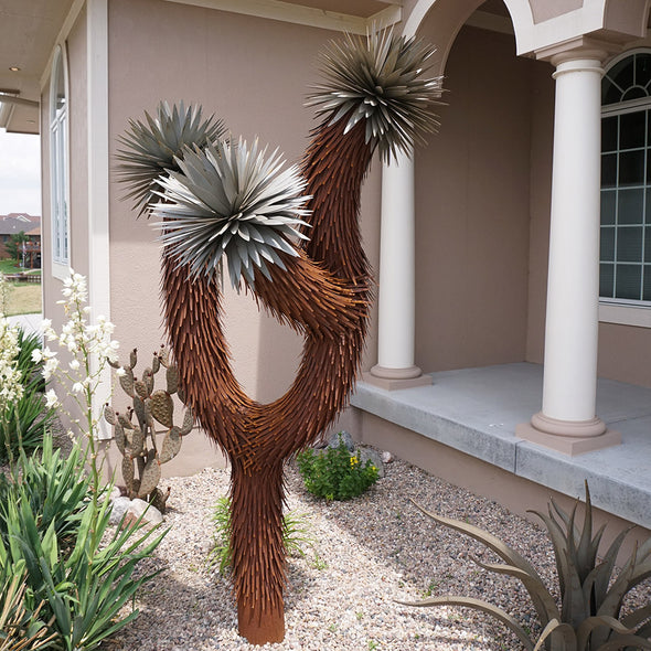 Three Arm Joshua Tree in landscape bed next to porch