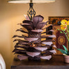 Pine Cone Luminary next to lamp on end table