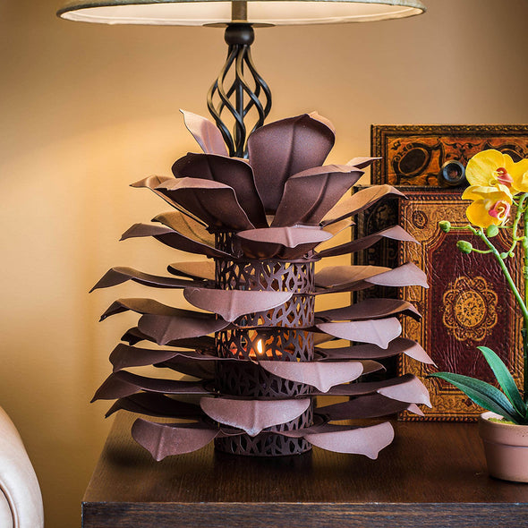 Pine Cone Luminary next to lamp on end table