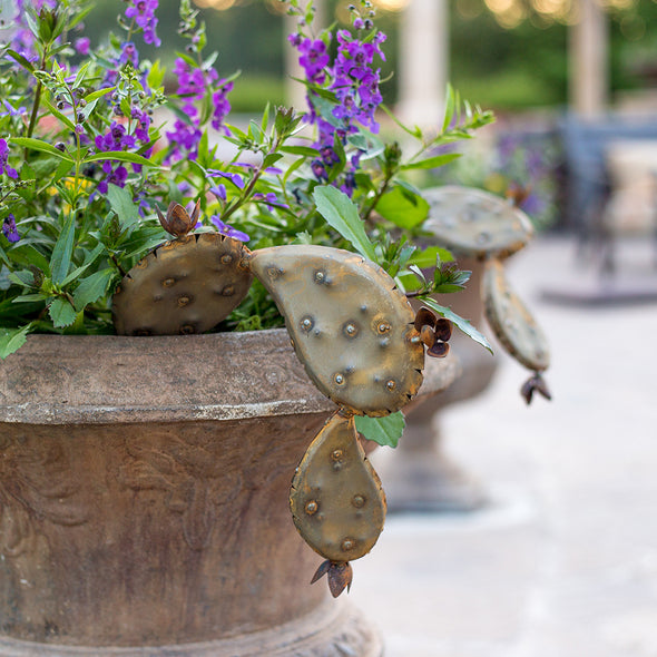 Landscape pot with flowers and steel prickly pear pops